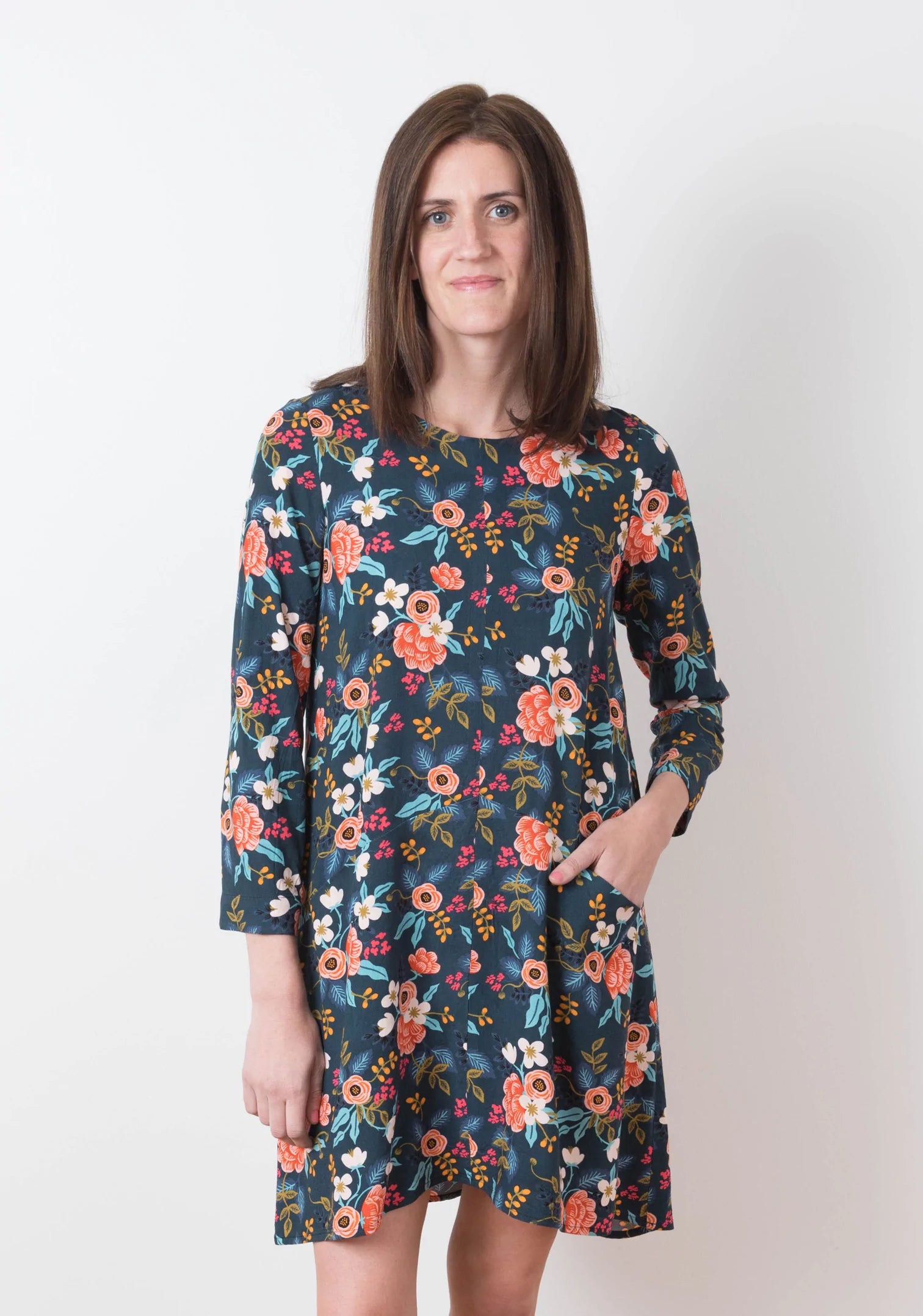 Model Kari is wearing a size 6 Farrow in a floral fabric, front view with pockets and sleeves.